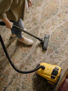 Cleaning person vacuuming floor